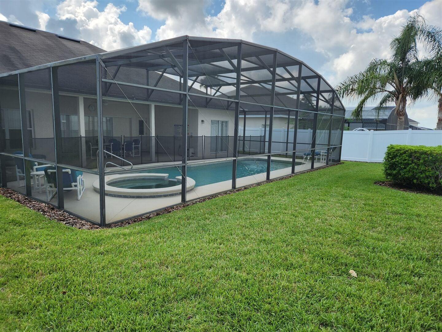 Screened pool enclosure and spa from the back garden