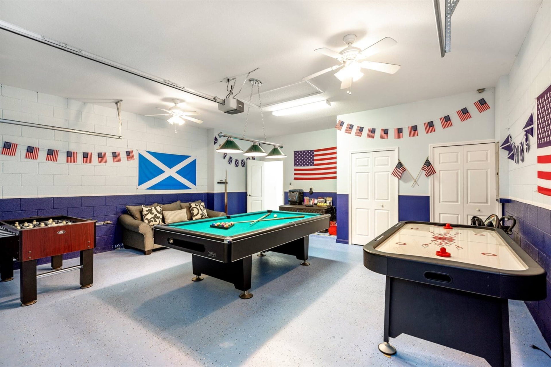 Garage games room with pool, foosball and air hockey